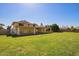 Large backyard with a well-maintained lawn and a view of the home's rear exterior at 5226 W Tierra Buena Ln, Glendale, AZ 85306