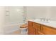 Bathroom with a tub-shower combination and wood-finish vanity at 5226 W Tierra Buena Ln, Glendale, AZ 85306