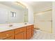 Bathroom featuring double sink vanity with a shower stall at 5226 W Tierra Buena Ln, Glendale, AZ 85306