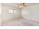 Bright bedroom featuring carpet flooring, ceiling fan, and a window with natural light at 5226 W Tierra Buena Ln, Glendale, AZ 85306