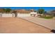 Home exterior with a large driveway leading to a two-car garage and gated yard at 5226 W Tierra Buena Ln, Glendale, AZ 85306