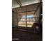 Horse stall showing metal framed gating, dirt floor and attached feed trough at 5226 W Tierra Buena Ln, Glendale, AZ 85306