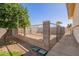 Fenced yard area with mature trees, lush foliage, and hardscaped border at 5226 W Tierra Buena Ln, Glendale, AZ 85306