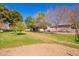 Spacious yard featuring green grass and mature trees at 5226 W Tierra Buena Ln, Glendale, AZ 85306