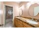 Bathroom with double sinks, granite countertops, decorative mirror and shower with decorative window at 5345 E Mercer Ln, Scottsdale, AZ 85254