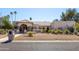 Charming single-story home with manicured desert landscaping and a stone walkway leading to the front door at 5345 E Mercer Ln, Scottsdale, AZ 85254