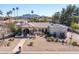 Expansive desert landscaping defines this single-story home with a large, flat roof and mountain views at 5345 E Mercer Ln, Scottsdale, AZ 85254