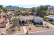 Expansive desert landscaping defines this single-story home with a large, flat roof and mountain views at 5345 E Mercer Ln, Scottsdale, AZ 85254