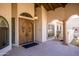 Arched front entrance with double doors and sidelights. A stone path guides visitors to the property at 5345 E Mercer Ln, Scottsdale, AZ 85254