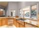 Kitchen with stainless steel sink under a window overlooking the pool and outdoor living space at 5345 E Mercer Ln, Scottsdale, AZ 85254