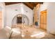 Living room with a stone fireplace and vaulted wood ceiling at 5345 E Mercer Ln, Scottsdale, AZ 85254