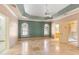 Spacious main bedroom with tray ceiling, a ceiling fan, and multiple windows at 5345 E Mercer Ln, Scottsdale, AZ 85254