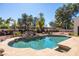 Beautiful pool with rock waterfall and a mature manicured garden at 5345 E Mercer Ln, Scottsdale, AZ 85254