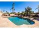 Inviting backyard swimming pool with lush landscaping, mature trees, and rock features at 5345 E Mercer Ln, Scottsdale, AZ 85254