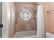 Shower with decorative window, travertine tile and shower curtain and rod at 5345 E Mercer Ln, Scottsdale, AZ 85254