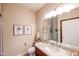 Well-lit bathroom featuring a granite vanity, modern fixtures, and decorative wall art at 5350 E Deer Valley Dr # 2246, Phoenix, AZ 85054