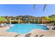 Resort-style community pool surrounded by seating and palm trees in a beautiful setting at 5350 E Deer Valley Dr # 2246, Phoenix, AZ 85054