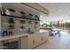 Stylish bar area with stone accent wall, open shelving, modern appliances, and seamless integration with the kitchen at 5910 N 45Th St, Phoenix, AZ 85018