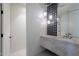 Modern powder room featuring a floating marble vanity with designer lighting and a textured backsplash at 5910 N 45Th St, Phoenix, AZ 85018