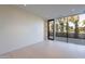 Minimalist bedroom with clean lines, tile floors, and a expansive windows to the manicured yard at 5910 N 45Th St, Phoenix, AZ 85018