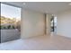 Spacious bedroom with a large window offering views of the gravel-filled landscaping at 5910 N 45Th St, Phoenix, AZ 85018