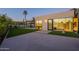 Well-manicured lawn surrounds this contemporary home featuring views into the main bedroom and bathroom at 5910 N 45Th St, Phoenix, AZ 85018