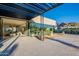 Modern home exterior featuring a covered patio, floor-to-ceiling windows, and a landscaped yard against a mountain backdrop at 5910 N 45Th St, Phoenix, AZ 85018