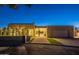 Modern home showcasing clean lines, artificial turf, and elegant landscaping at twilight at 5910 N 45Th St, Phoenix, AZ 85018