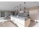 Bright kitchen featuring a large center island with seating and stone backsplash with light wood cabinets at 5910 N 45Th St, Phoenix, AZ 85018