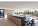 Bright kitchen with light wood cabinets, stainless steel appliances, and large windows overlooking the outside dining area at 5910 N 45Th St, Phoenix, AZ 85018