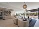 Spacious living area showcasing modern decor, integrated bar area, and glass doors opening to a serene outdoor space at 5910 N 45Th St, Phoenix, AZ 85018