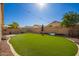 The synthetic grass and gravel landscaping create a visually appealing and low-maintenance outdoor space at 661 E Redondo Dr, Gilbert, AZ 85296