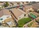 Aerial view of a fenced backyard featuring a lush artificial lawn, pool, and patio area at 661 E Redondo Dr, Gilbert, AZ 85296