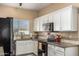 Well-equipped kitchen with stainless steel appliances and granite countertops at 661 E Redondo Dr, Gilbert, AZ 85296