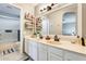 Bright bathroom features double sink vanity and modern fixtures, with decoratively placed shelving and neutral colors at 6938 W Wescott Dr, Glendale, AZ 85308