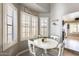 Bright breakfast nook featuring white table and chairs complemented by shuttered windows and gray walls at 6938 W Wescott Dr, Glendale, AZ 85308