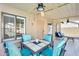 Covered patio featuring an outdoor dining area, with cushioned seating, a ceiling fan, and views of the backyard at 6938 W Wescott Dr, Glendale, AZ 85308