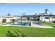 Backyard pool area with lounge chairs, a spacious patio, lush green grass, and inviting outdoor seating at 7333 E Palm Ln, Scottsdale, AZ 85257