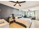 This bedroom has a gray accent wall, light wood floors, and a seating area with a blue sofa at 7333 E Palm Ln, Scottsdale, AZ 85257