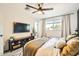 Comfortable bedroom featuring a modern ceiling fan, window with natural light, and soft, inviting decor at 7333 E Palm Ln, Scottsdale, AZ 85257