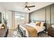 Cozy bedroom featuring a modern ceiling fan, stylish accent wall, and comfortable furnishings at 7333 E Palm Ln, Scottsdale, AZ 85257