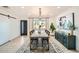 Modern dining room with a long wooden table, seating for eight, stylish decor, and a contemporary rug at 7333 E Palm Ln, Scottsdale, AZ 85257