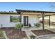 Charming home entrance with well-maintained landscaping, a dark wood door, and a welcoming front porch at 7333 E Palm Ln, Scottsdale, AZ 85257