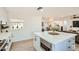 Kitchen island with seating and microwave features quartz countertops, stainless appliances, and an open concept design at 7333 E Palm Ln, Scottsdale, AZ 85257