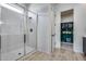 Modern bathroom features marble shower with glass enclosure and an organized closet at 7694 W Desert Spoon Dr, Peoria, AZ 85383