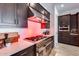 Modern kitchen features a stainless steel gas range, quartz counters, and dark wood cabinetry at 7694 W Desert Spoon Dr, Peoria, AZ 85383