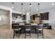 Bright kitchen with stainless steel appliances, quartz countertops, and stylish pendant lighting at 7694 W Desert Spoon Dr, Peoria, AZ 85383