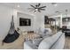 Bright living room featuring hardwood floors, modern furnishings and a cozy hammock chair at 7694 W Desert Spoon Dr, Peoria, AZ 85383