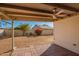 Covered back patio features brick pavers and ceiling fan overlooking the spacious backyard at 7737 W Cherry Hills Dr, Peoria, AZ 85345