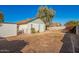 View of backyard showcasing lawn, shed and home's architectural details at 7737 W Cherry Hills Dr, Peoria, AZ 85345